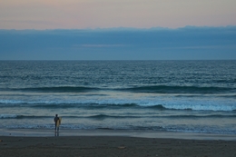 man waiting for waves in late summer 